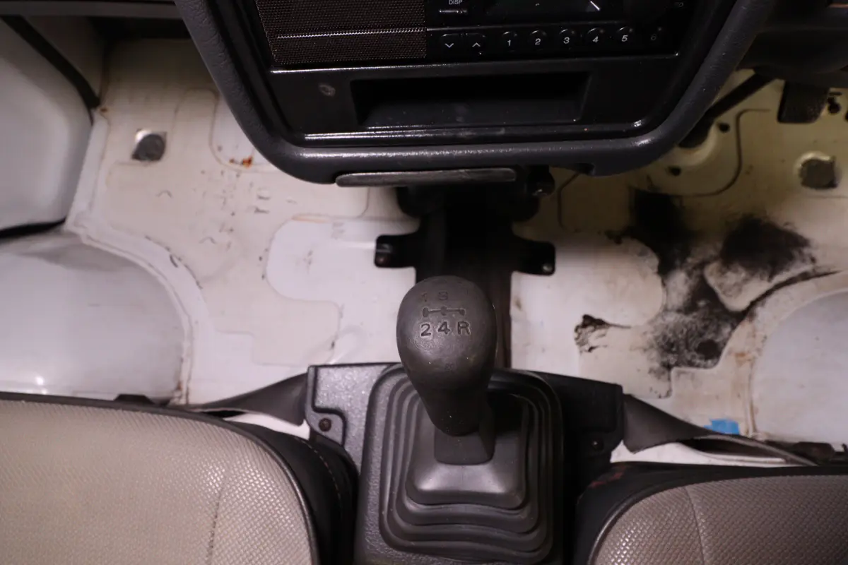 White 1991 Suzuki Carry Dump Bed 4x4 Kei Truck, gear shifter, for sale at Duncan Imports in Christiansburg, VA