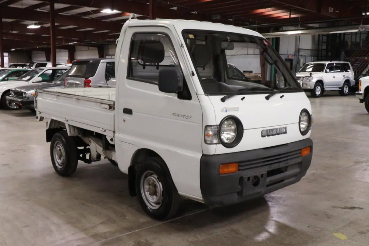 White 1991 Suzuki Carry Dump Bed 4x4 Kei Truck, front three-quarter view, for sale at Duncan Imports in Christiansburg, VA