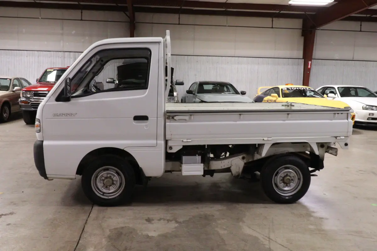 White 1991 Suzuki Carry Dump Bed 4x4 Kei Truck, side view, for sale at Duncan Imports in Christiansburg, VA