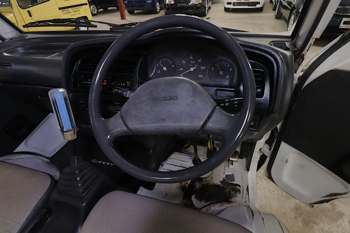 White 1993 Suzuki Carry 4x4 Kei Truck, steering wheel and dashboard, for sale at Duncan Imports in Christiansburg, VA