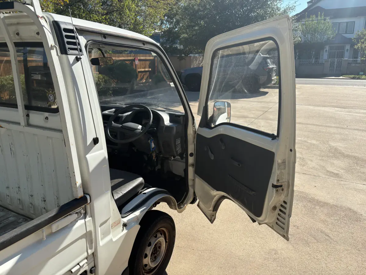 1995 Subaru Sambar 4x4 Kei Truck, open cab door, for sale at Sunshine Imports in Austin, TX