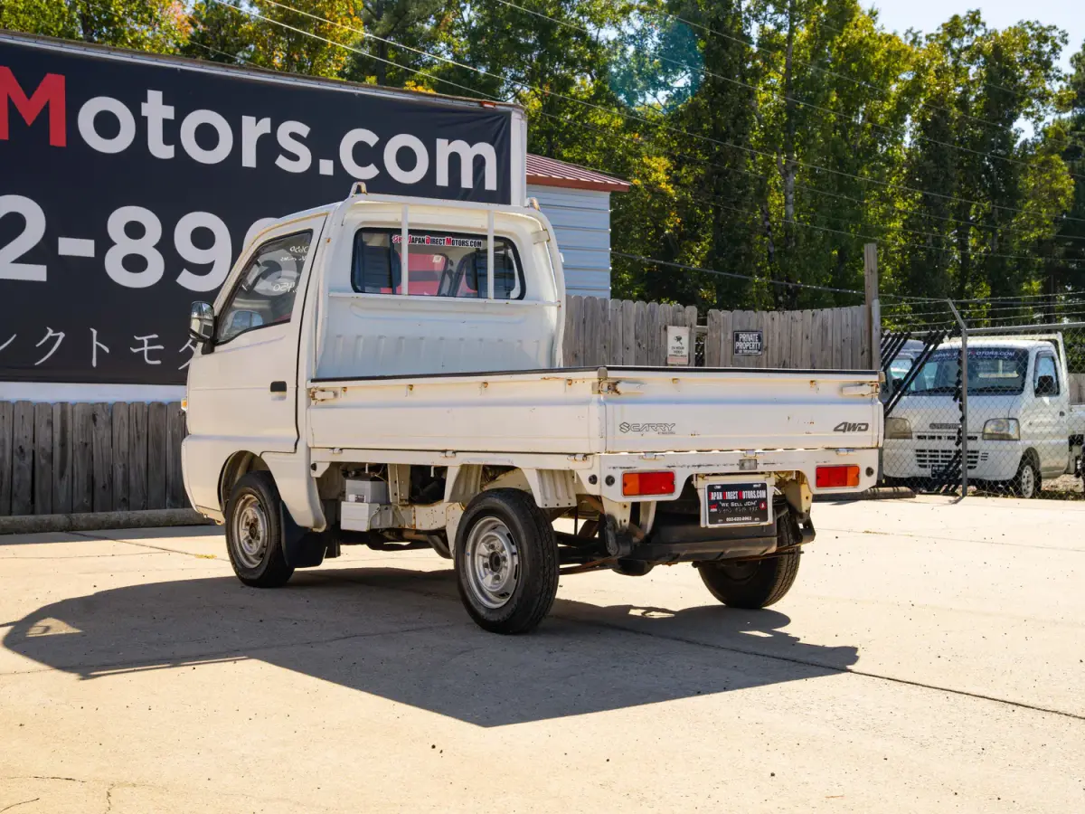 White 1995 Suzuki Carry 4x4 Kei Truck, rear three-quarter view, for sale at Japan Direct Motors in Irmo, SC