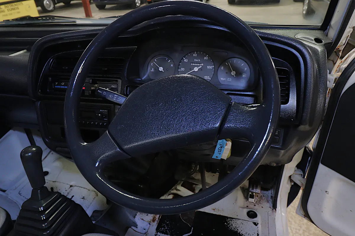 White 1996 Suzuki Carry Dump Bed 4x4 Kei Truck, steering wheel and dashboard, for sale at Duncan Imports in Christiansburg, VA