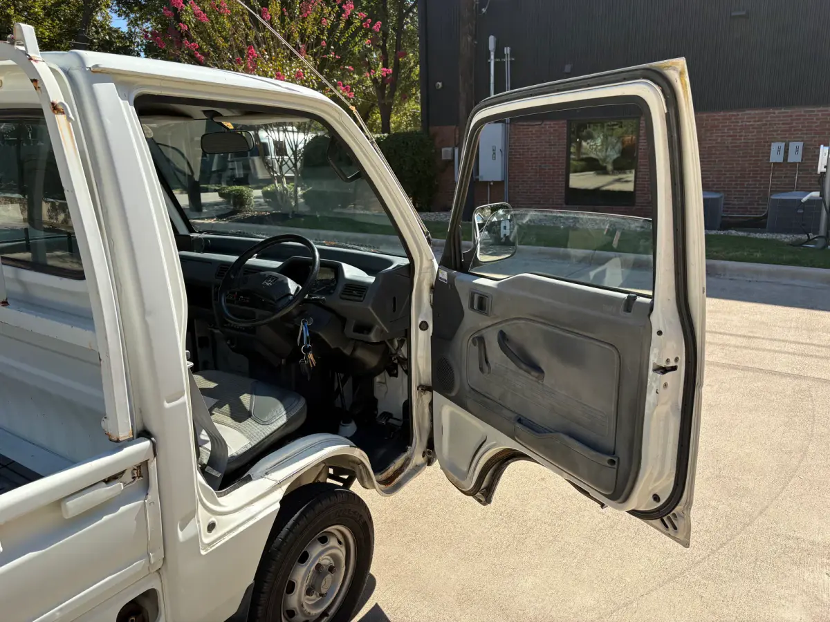 1997 Honda Acty 4x4 Kei Truck, cab interior with door open, for sale at Sunshine Imports in Austin, TX