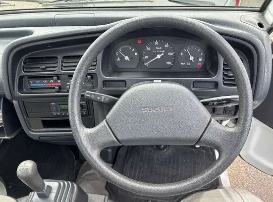 1997 Suzuki Carry 4WD Dump Truck, a white off-road Kei Truck, for sale at Weatherford Mini Trucks in Weatherford, TX (photo 2 of 6)