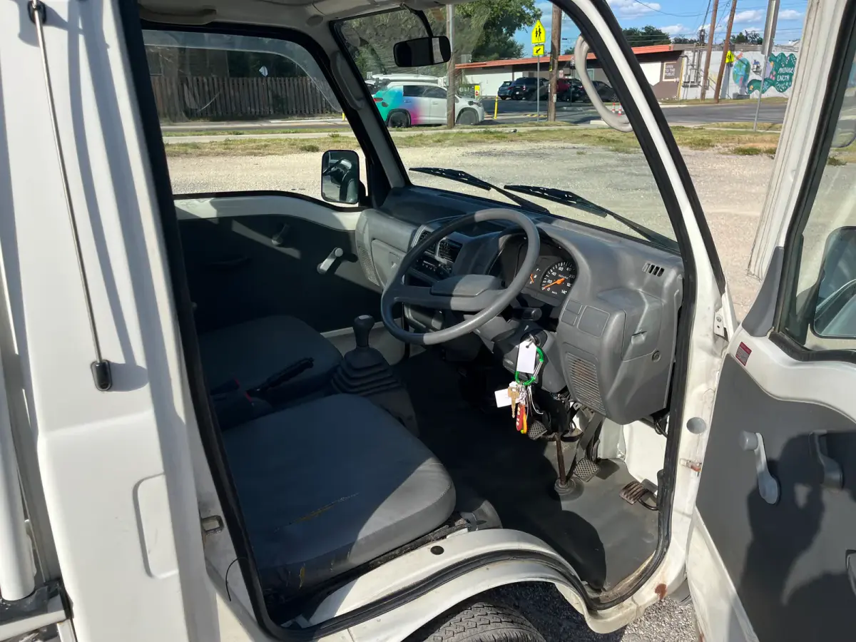 1998 Subaru Sambar 4x4 Kei Truck, cab interior, sold at Sunshine Imports in Austin, TX