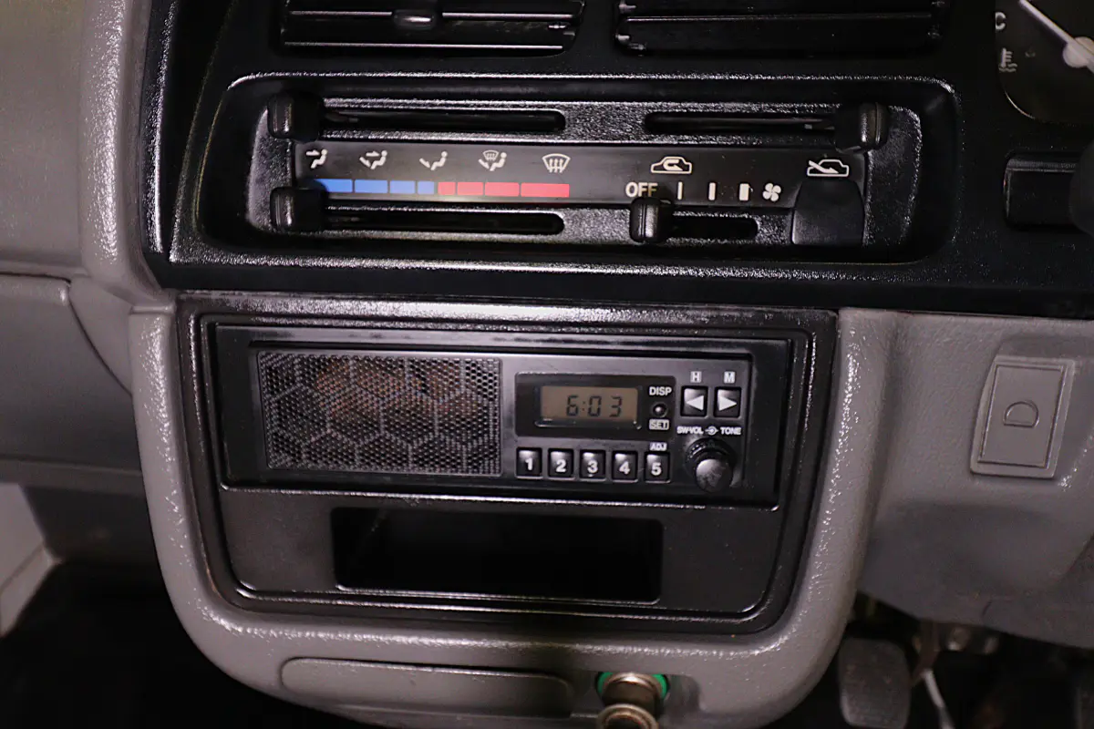 White 1998 Suzuki Carry 4x4 Kei Truck, radio and heater controls, for sale at Duncan Imports in Christiansburg, VA