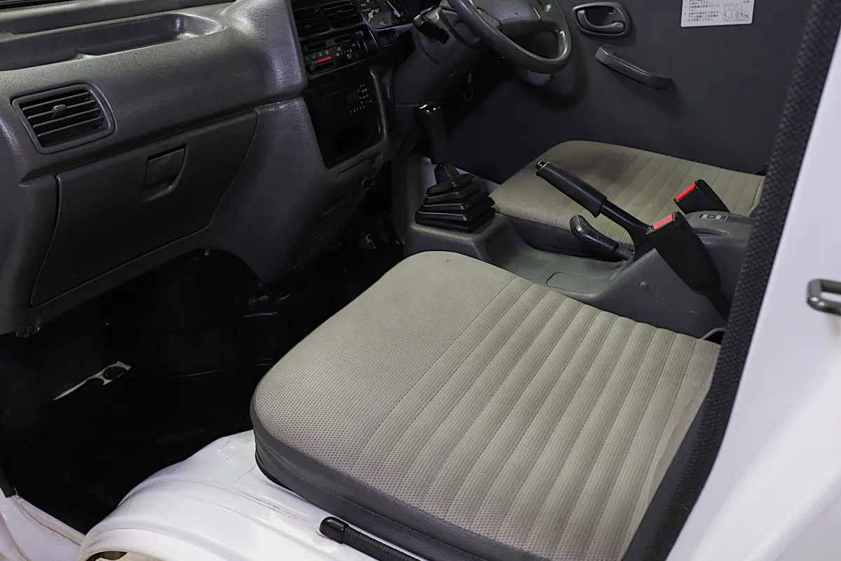 White 1998 Suzuki Carry 4x4 Kei Truck, cab interior from open door, for sale at Duncan Imports in Christiansburg, VA