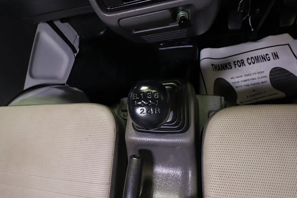 White 1998 Suzuki Carry 4x4 Kei Truck, gear shifter, for sale at Duncan Imports in Christiansburg, VA