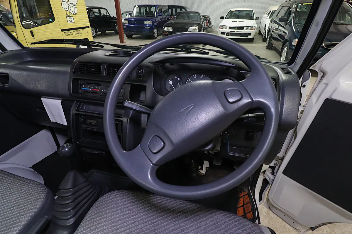 White 1999 Daihatsu Hijet 4x4 Kei Truck, steering wheel and dashboard, for sale at Duncan Imports in Christiansburg, VA