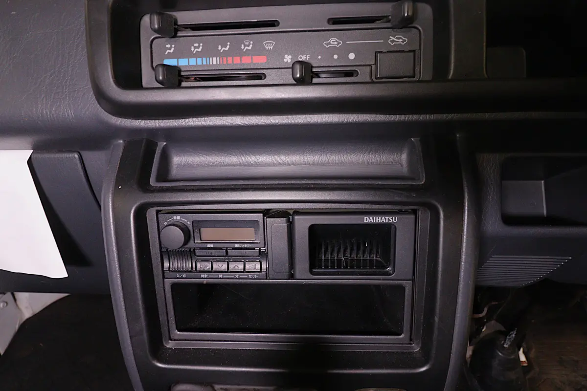 White 1999 Daihatsu Hijet 4x4 Kei Truck, heater and radio controls, for sale at Duncan Imports in Christiansburg, VA