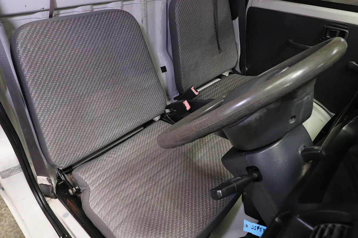 White 1999 Daihatsu Hijet 4x4 Kei Truck, seats and steering wheel, for sale at Duncan Imports in Christiansburg, VA