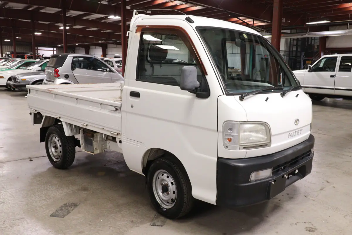 White 1999 Daihatsu Hijet 4x4 Kei Truck, front three-quarter view, for sale at Duncan Imports in Christiansburg, VA