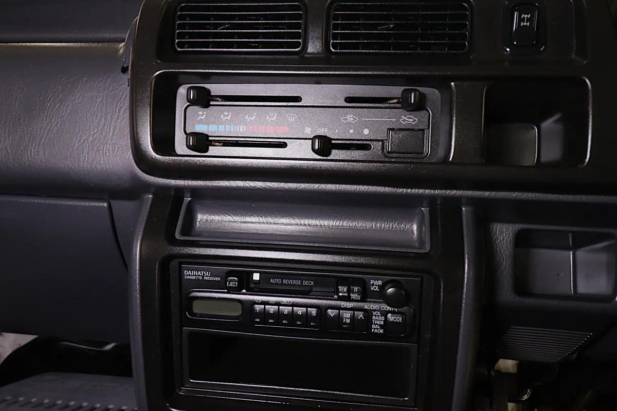 White 1999 Daihatsu Hijet 4x4 Kei Truck, heater controls and radio, for sale at Duncan Imports in Christiansburg, VA