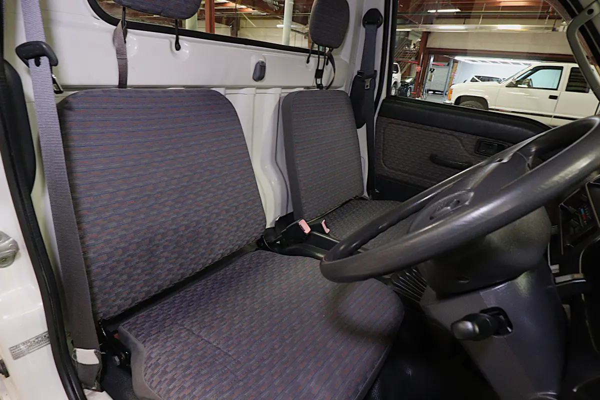 White 1999 Daihatsu Hijet 4x4 Kei Truck, seats and steering wheel, for sale at Duncan Imports in Christiansburg, VA