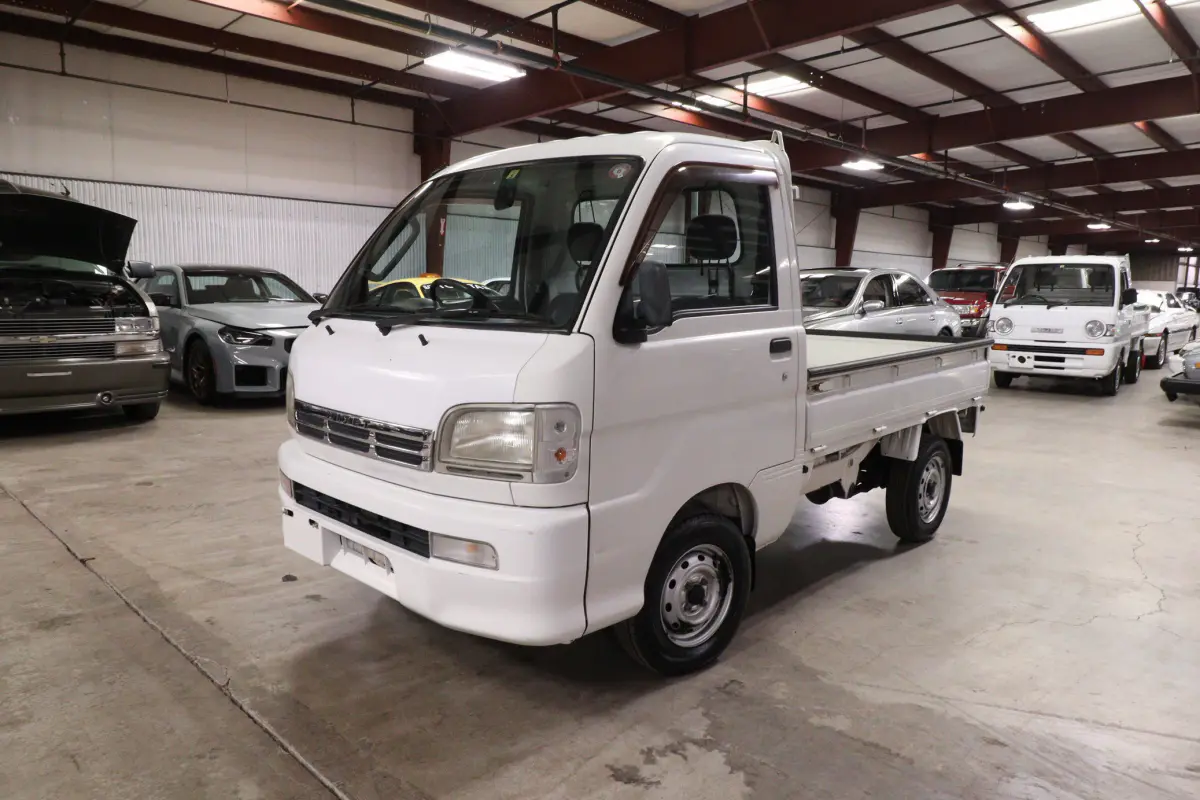 White 1999 Daihatsu Hijet 4x4 Kei Truck, front three-quarter view, for sale at Duncan Imports in Christiansburg, VA