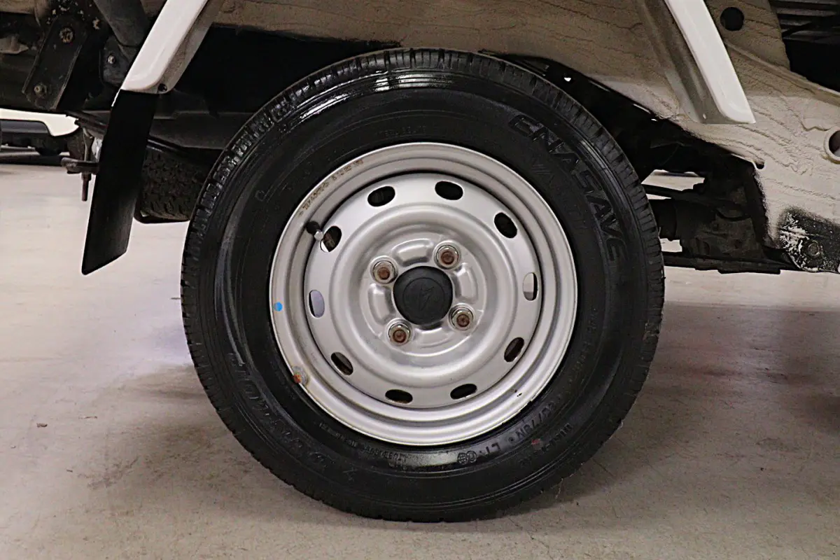 White 1999 Daihatsu Hijet 4x4 Kei Truck, rear wheel and tire, for sale at Duncan Imports in Christiansburg, VA