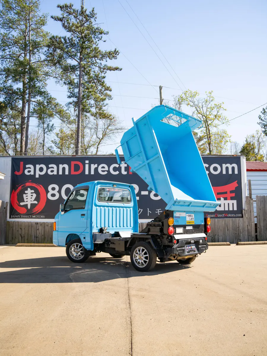 1999 Subaru Sambar Dump Bed, a blue Kei Truck, for sale at Japan Direct Motors in Irmo, SC (photo 2 of 12)