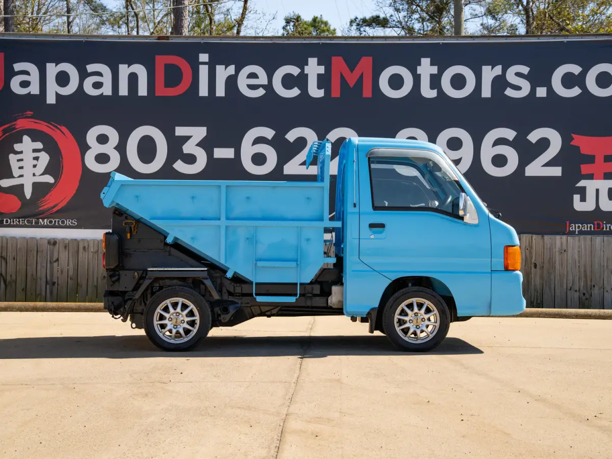 1999 Subaru Sambar Dump Bed, a blue Kei Truck, for sale at Japan Direct Motors in Irmo, SC (photo 7 of 12)