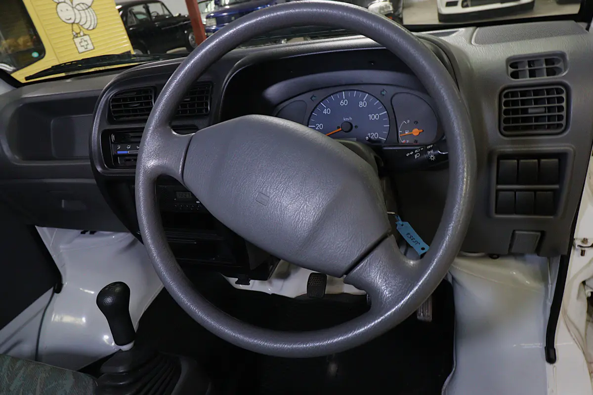 White 1999 Suzuki Carry 4x4 Kei Truck, steering wheel and dashboard, for sale at Duncan Imports in Christiansburg, VA