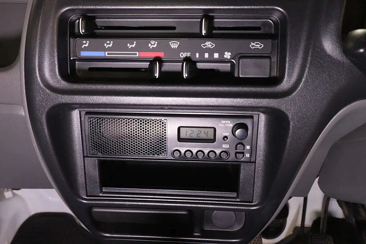 White 1999 Suzuki Carry 4x4 Kei Truck, heater controls and radio, for sale at Duncan Imports in Christiansburg, VA