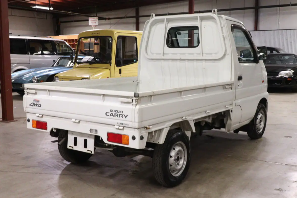 White 1999 Suzuki Carry 4x4 Kei Truck, rear three-quarter view, for sale at Duncan Imports in Christiansburg, VA