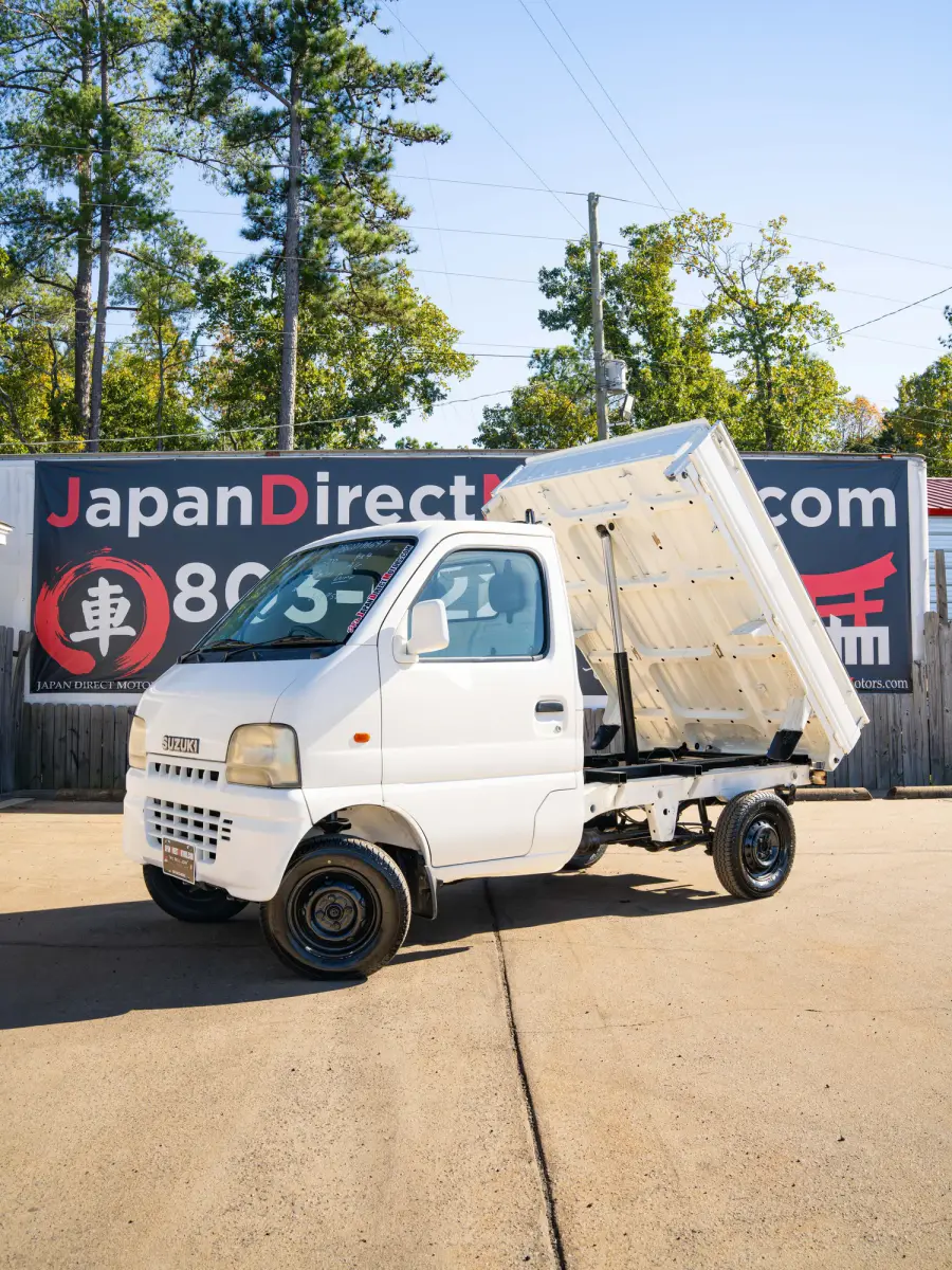 White 2000 Suzuki Carry Dump Bed 4x4 Kei Truck, front three-quarter view with raised dump bed, for sale at Japan Direct Motors in Irmo, SC
