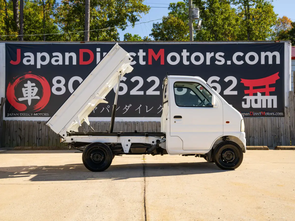 White 2000 Suzuki Carry Dump Bed 4x4 Kei Truck, side view with raised dump bed, for sale at Japan Direct Motors in Irmo, SC