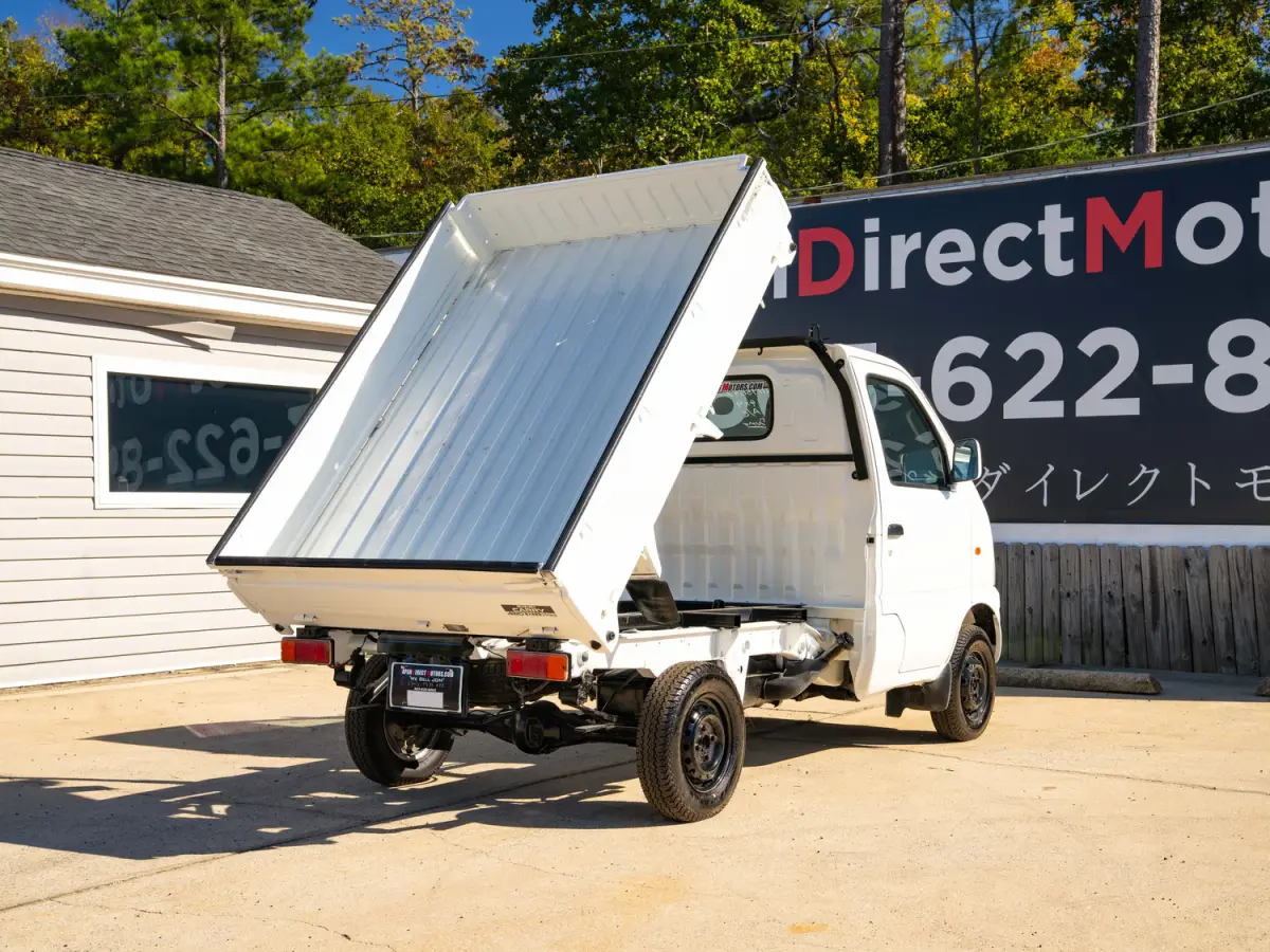 White 2000 Suzuki Carry Dump Bed 4x4 Kei Truck, rear three-quarter view with raised dump bed, for sale at Japan Direct Motors in Irmo, SC