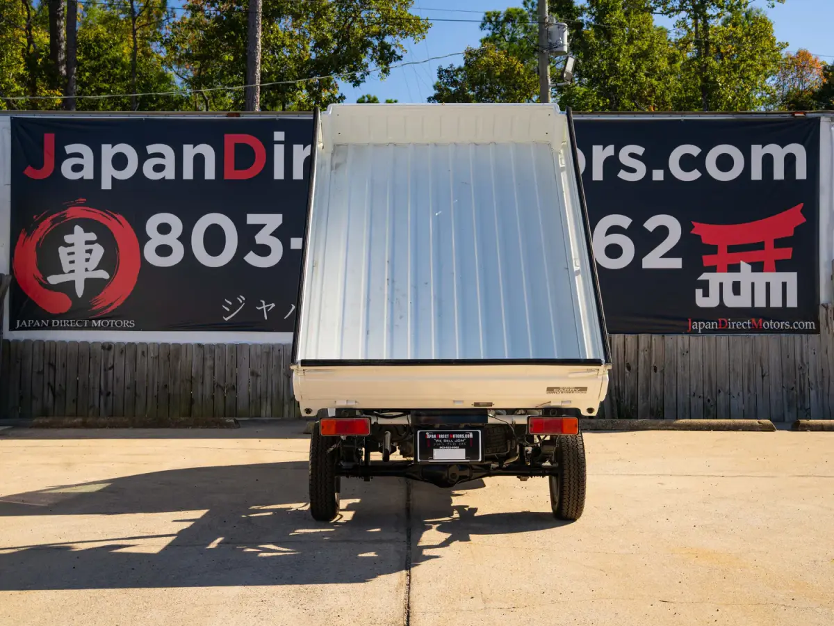 White 2000 Suzuki Carry Dump Bed 4x4 Kei Truck, rear view with raised dump bed, for sale at Japan Direct Motors in Irmo, SC