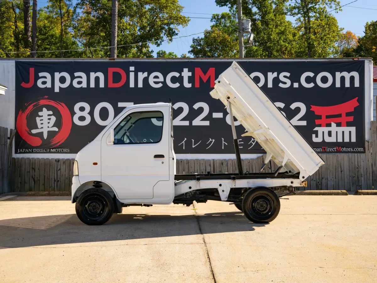 White 2000 Suzuki Carry Dump Bed 4x4 Kei Truck, side view with raised dump bed, for sale at Japan Direct Motors in Irmo, SC